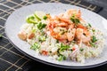 Couscous with roasted shrimps, tomatoes, red onions, almond nuts and parsley. Royalty Free Stock Photo