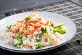 Couscous with roasted shrimps, tomatoes, red onions, almond nuts and parsley. Royalty Free Stock Photo