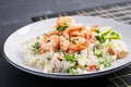 Couscous with roasted shrimps, tomatoes, red onions, almond nuts and parsley. Royalty Free Stock Photo