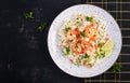 Couscous with roasted shrimps, tomatoes, red onions, almond nuts and parsley. Royalty Free Stock Photo