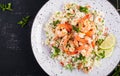 Couscous with roasted shrimps, tomatoes, red onions, almond nuts and parsley. Royalty Free Stock Photo