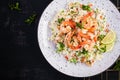 Couscous with roasted shrimps, tomatoes, red onions, almond nuts and parsley. Royalty Free Stock Photo