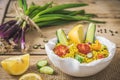 Couscous salad with cucumber, tomatoes and onions in a white bowl on rustic wooden background Royalty Free Stock Photo