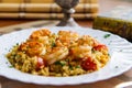 Couscous with shrimps and vegetables in a plate