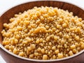 Couscous in wooden bowl on white background Royalty Free Stock Photo