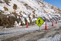 Coution sign board on snow road at the snow hill Royalty Free Stock Photo