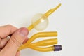 Couvelaire tip latex urology catheter with three lumens held in left hand