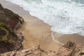 Cove on Almagreira beach with a Sunday fisherman in the central Portuguese Western coast, in Peniche