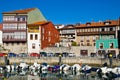 Cove with boats, old houses stand around.