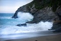 The cove with rushing waves against mountains near the Lusty Glaze Restaurant in Newquay, Cornwall, England.