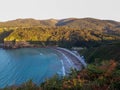 Cove in a sunset with a calm sea. Crystal clear blue water. Caravan parking on the beach in Asturias, Spain Royalty Free Stock Photo