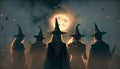 Coven of witches, viewed from the back. Walpurgis night, Halloween. Moon rising