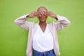 Cover eyes, playful and a black woman on a green background for comedy, happiness or fun. Pouting, hide or an African Royalty Free Stock Photo