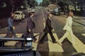 Cover of the famous Beatles Abbey Road album with a turntable in the foreground.
