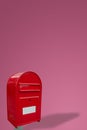 Cover page with big fancy red metal postbox with white empty note space for address isolated at pink gradient background with copy