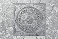 The cover of a sewer manhole on the pavement, with the inscription Zaryadye in Russian. Royalty Free Stock Photo