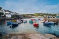 Small boats and fishermen in the Coverack harbour. A coastal village and fishing port in Cornwall, Royalty Free Stock Photo
