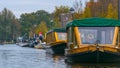 Covered boats, on the water channels in Giethoorn, the Netherlands and the trees, on a fall day