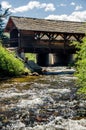 Covered bridge in the Colorado Rocky Mountains with flowing stream