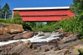 Covered bridge over a fast moving water stream. Royalty Free Stock Photo