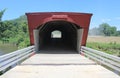 Covered Bridge Painted Red with a White Fence