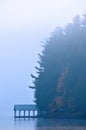 Covered dock on misty adirondack lake Royalty Free Stock Photo