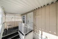 Covered elevated patio of a house with lattice privacy wall