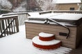 Covered hot tub on a residential porch in a snow storm