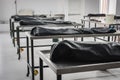 Covered human corpses on tables in a morgue / mortuary waiting for identification, autopsy, burial or cremation. Taken in Armenia