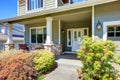 Covered porch with white columns and stone trim. Royalty Free Stock Photo