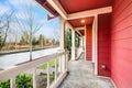 Covered red front porch with railings Royalty Free Stock Photo