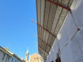 Covered scaffolding by a building under renovation Royalty Free Stock Photo