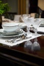 Covered served dinner table with expensive white dishes and glasses Royalty Free Stock Photo