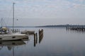 Covered and tied boats at the jetty in a lake in the morning Royalty Free Stock Photo