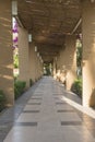 Covered tiled pathway with columns in formal garden