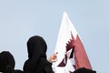Covered women and Qatar flag