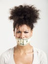 Covering mouth with a dollar banknote