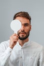 Covering right eye. Man is checking his vision indoors in the clinic Royalty Free Stock Photo