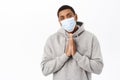 Covid awareness, healthcare concept. Image of concerned african american man in medical mask, begging you, pleading with Royalty Free Stock Photo