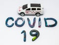Covid 19 concept, ambulance car and plasticine in word "COVID19" on white background. Royalty Free Stock Photo