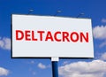 Covid-19 corona deltacron symbol. The concept word Deltacron on white billboard. Beautiful blue sky. Medical and COVID-19 corona