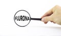 Covid-19 corona and flu flurona symbol. The concept word flurona. Magnifying glass. Doctor hand. Beautiful white table, white