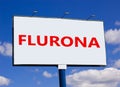 Covid-19 corona and flu flurona symbol. The concept word Flurona on white billboard. Beautiful blue sky. Medical and COVID-19