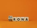 Covid-19 corona and flu flurona symbol. Turned a cube and changed the word corona to flurona. Beautiful orange table, orange