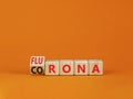 Covid-19 corona and flu flurona symbol. Turned a cube and changed the word corona to flurona. Beautiful orange table, orange