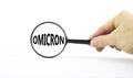 Covid-19 corona and omicron symbol. The concept word Omicron. Magnifying glass. Doctor hand. Beautiful white table, white