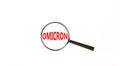 Covid-19 corona and omicron symbol. The concept word Omicron. Magnifying glass. Beautiful white table, white background. Medical