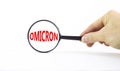 Covid-19 corona and omicron symbol. The concept word Omicron. Magnifying glass. Doctor hand. Beautiful white table, white