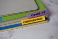 Covid 19 - Corona Virus write on a sticky note isolated on Office Desk. File document concept Royalty Free Stock Photo