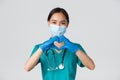 Covid-19, coronavirus disease, healthcare workers concept. Close-up of charming smiling asian female doctor, physician